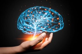 Hand Holding Glowing Brain