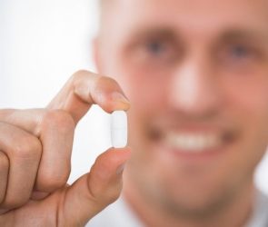 Male Doctor Holding Pill Medicine Drug Close