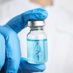 Scientist Holding DNA Strand Technology Vaccine Vial