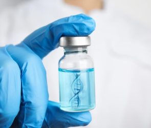 Scientist Holding DNA Strand Technology Vaccine Vial