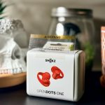 The SHOKZ OpenDots ONE clip-on earbuds are a high-energy reset in red