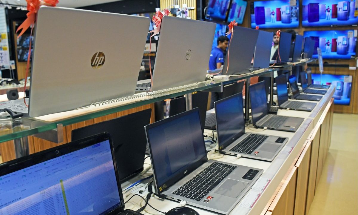 Laptops of different brands are kept on display at Vijay Sales electronic store.