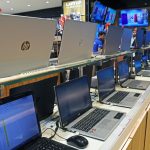 Laptops of different brands are kept on display at Vijay Sales electronic store.
