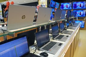 Laptops of different brands are kept on display at Vijay Sales electronic store.