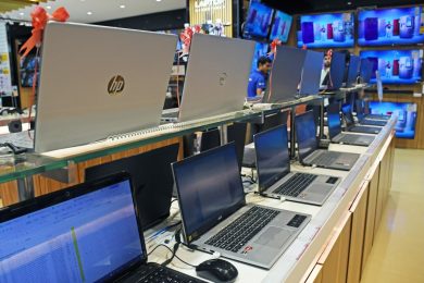 Laptops of different brands are kept on display at Vijay Sales electronic store.