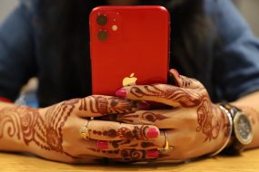 red iPhone held in two hands