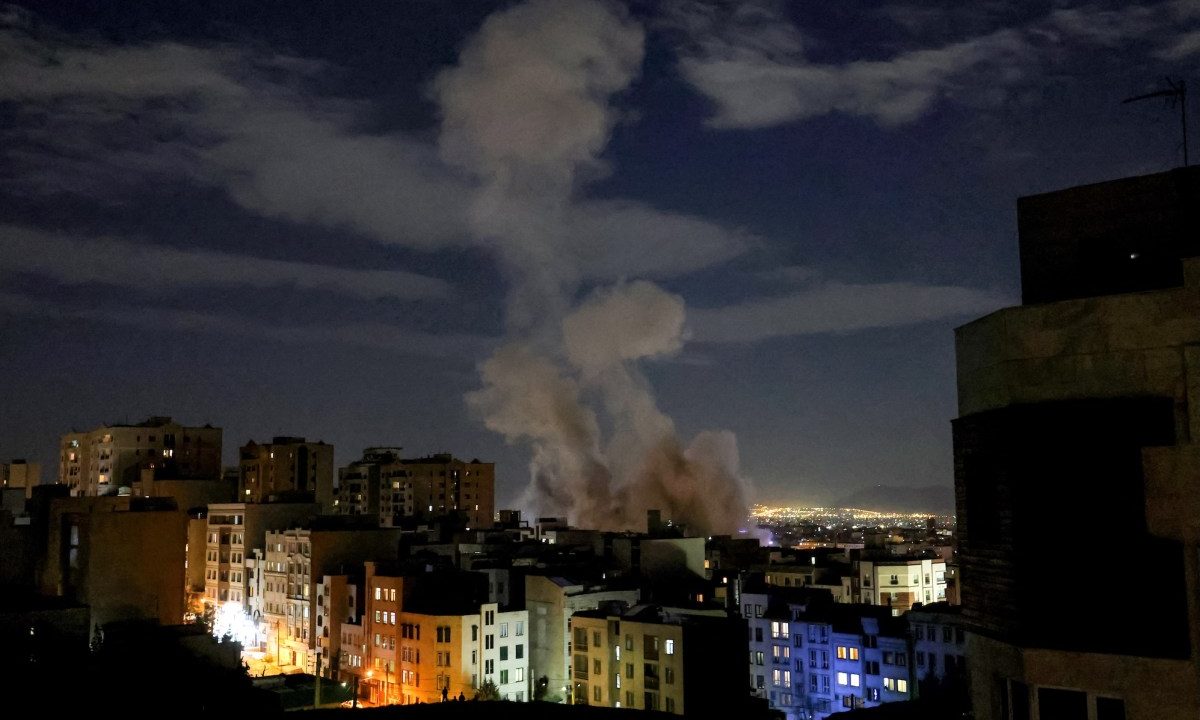 A smoke plume rises following a missile strike on a building in Tehran on March 1, 2026.