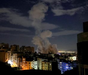 A smoke plume rises following a missile strike on a building in Tehran on March 1, 2026.