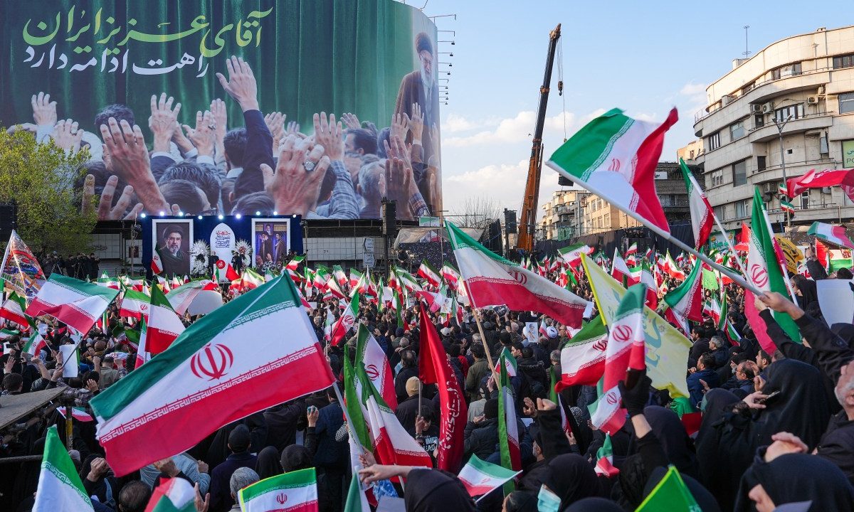 Demonstrators wave Iranian national flags as they gather for a rally in support of the new Supreme Leader at Enghelab Square in central Tehran on March 9, 2026. Iran marked the appointment of Ayatollah Mojtaba Khamenei to replace his father as Supreme Leader after Ayatollah Ali Khamenei was killed in joint U.S. and Israeli strikes on February 28.