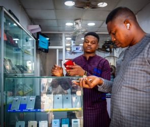 A customer browses mobile phone handsets inside a shop at the Ikeja computer village market in Lagos, Nigeria, on Monday, March 29, 2021.