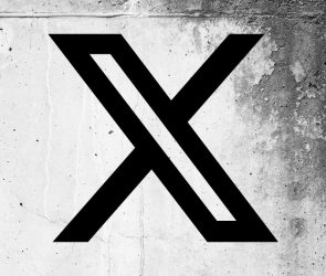 X (formerly Twitter) logo on a cracked wall